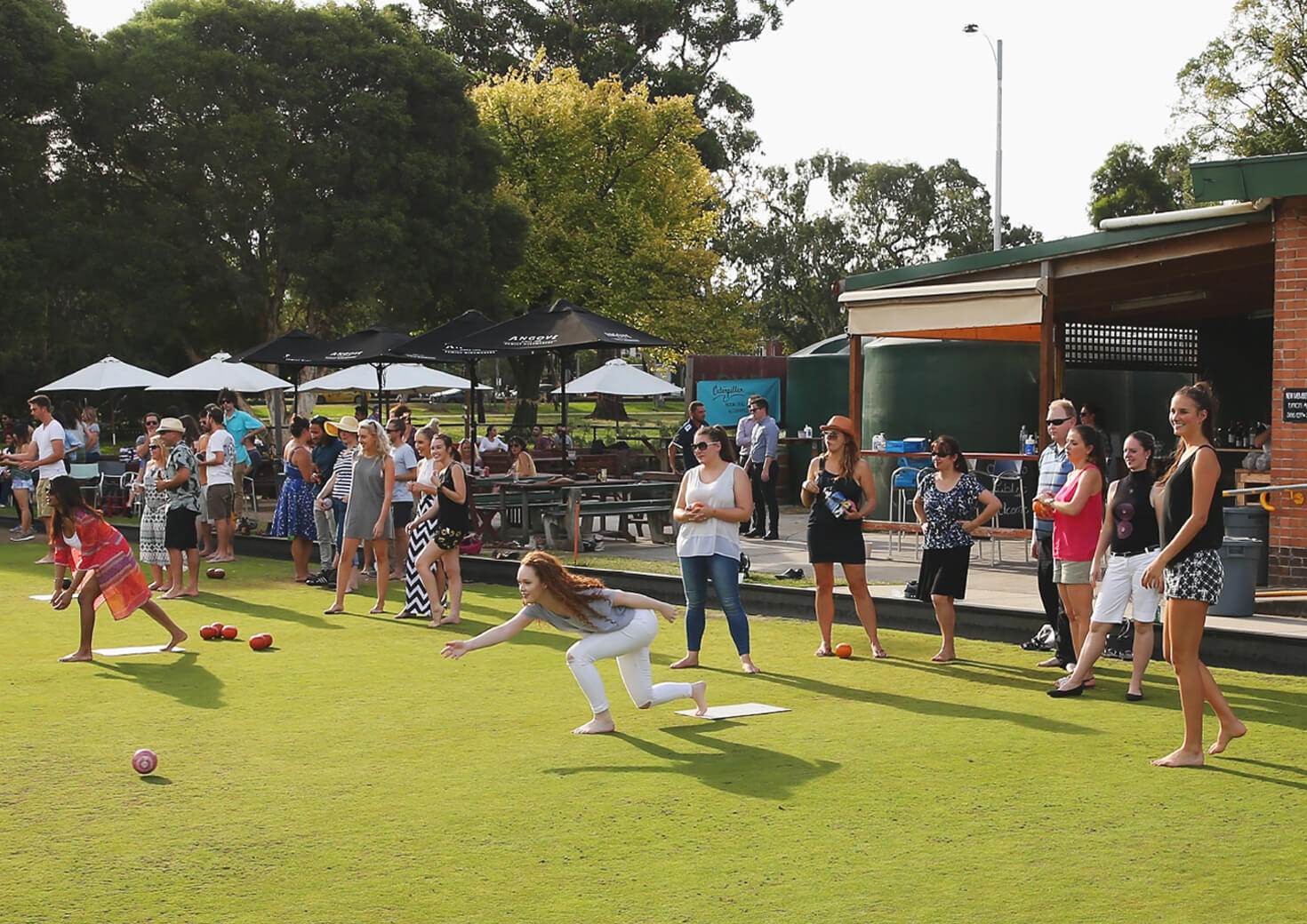 Young people playing bowls game